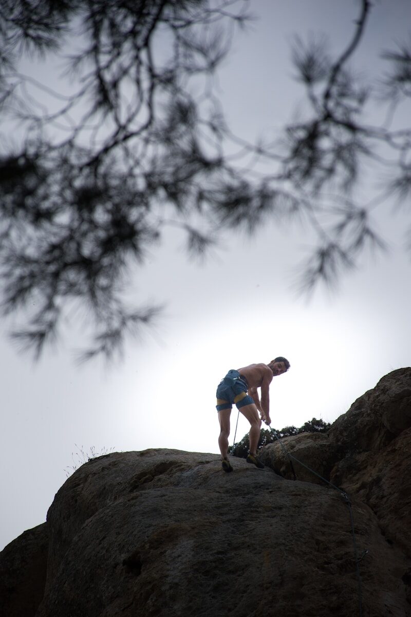 a man climbing up the side of a mountain